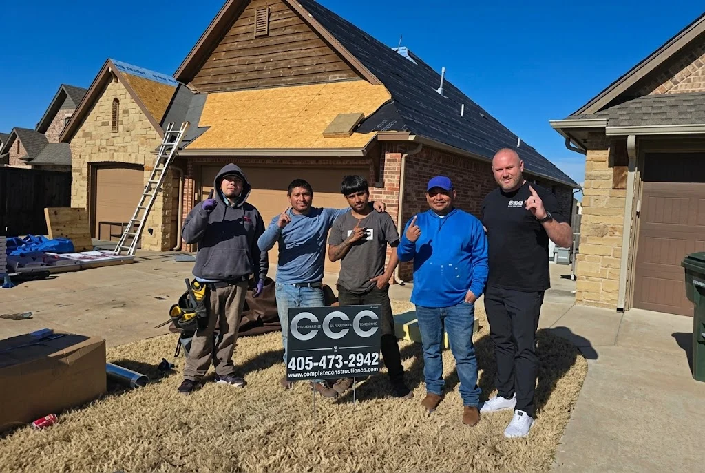 Construction crew and roofing materials on a residential job site, showcasing professional tools and equipment ready for installation.