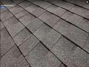 Charcoal gray architectural asphalt shingles installed in overlapping rows with clean alignment