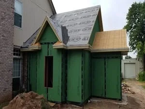 New roof framing with synthetic underlayment and gable construction during residential roof replacement